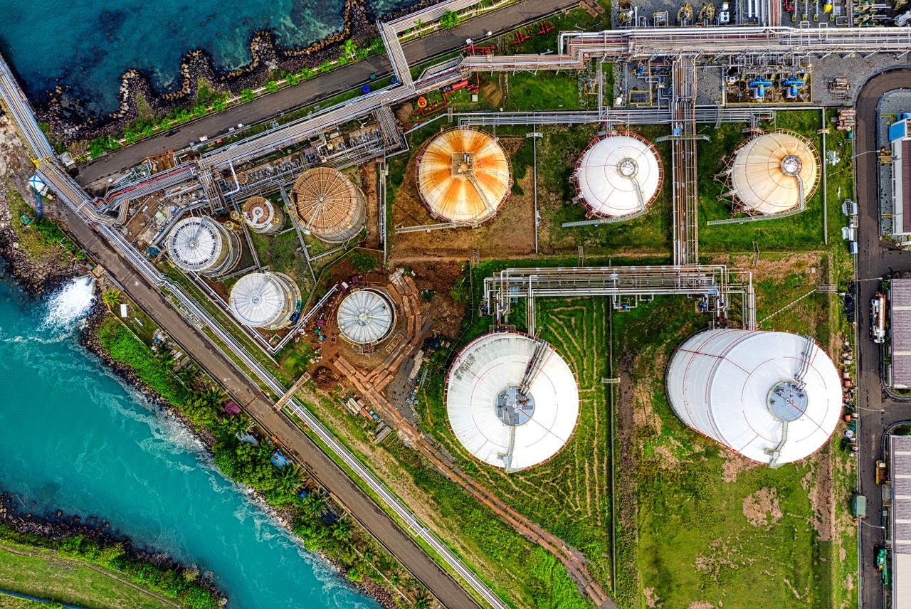 Home Aerial view of an industrial complex near a river in Banten, Indonesia, showcasing storage tanks.